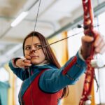 Woman in Blue Top Holding a Bow