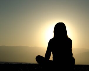 woman sitting on sand